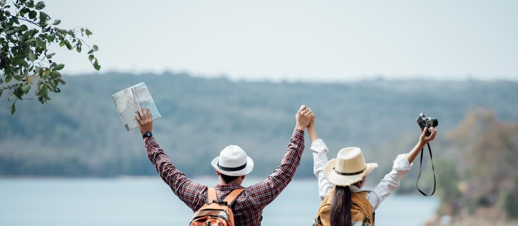 Couple holding hands in front of mountain 